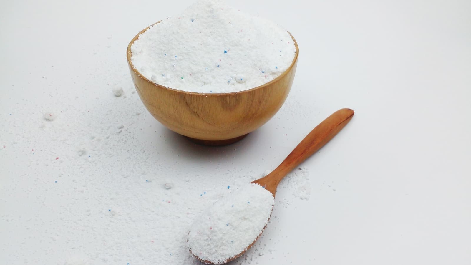 White baking soda in a wooden bowl with a spoon