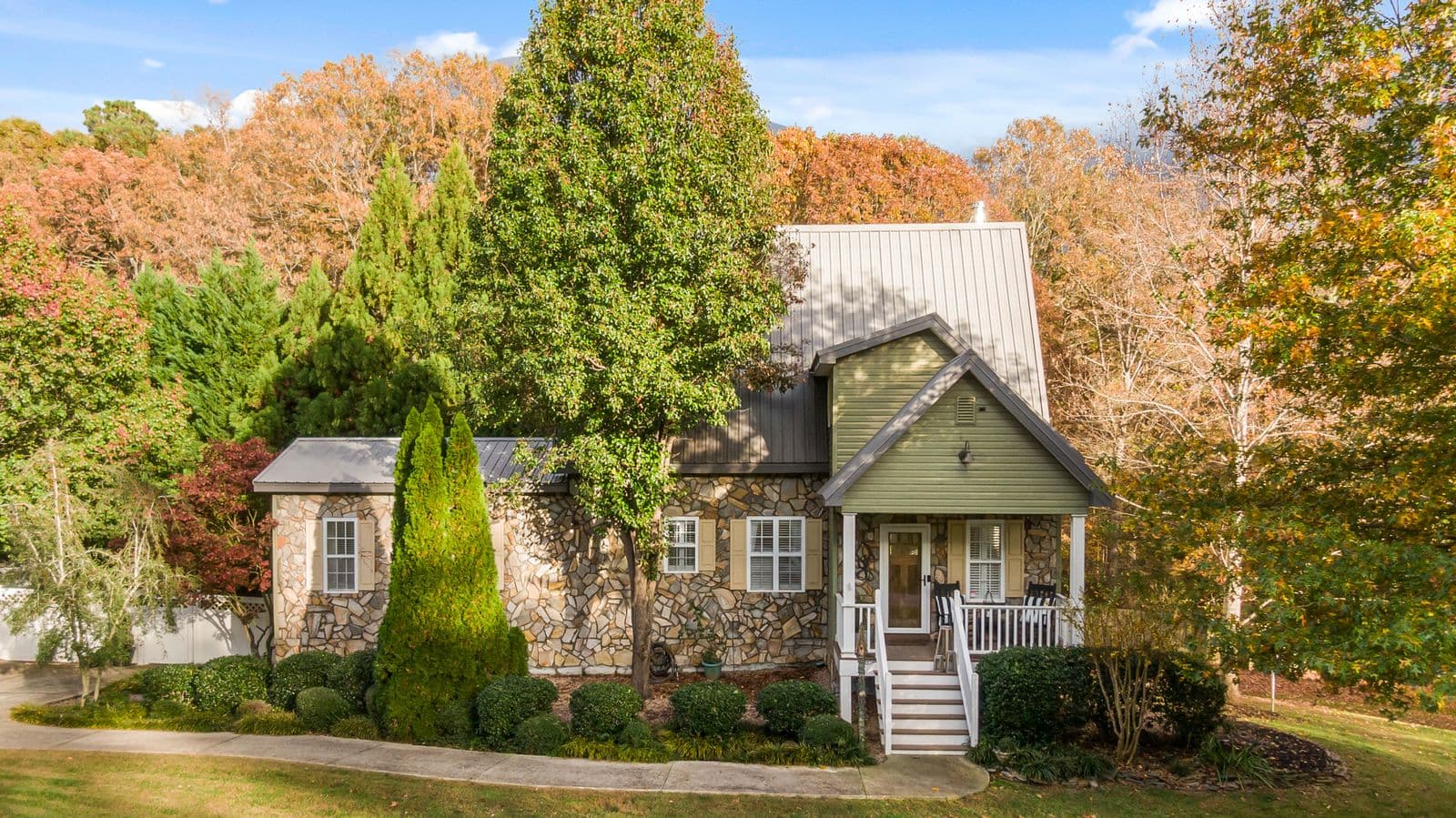 A house framed by trees in full autumn color