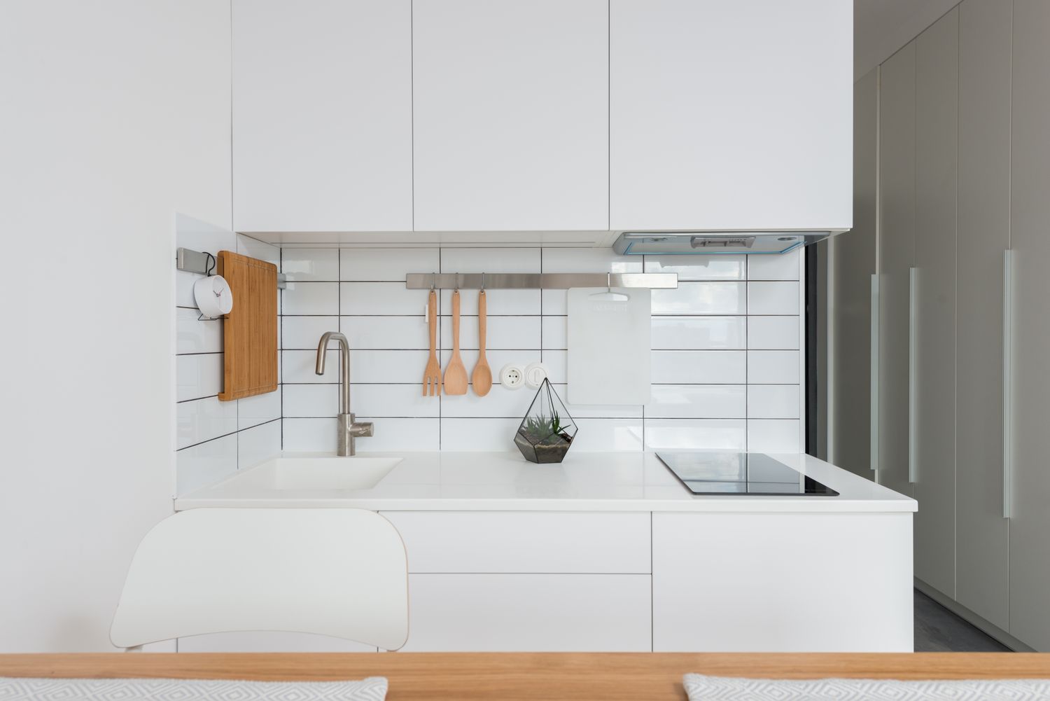 A spotless minimal white kitchen with clear counters