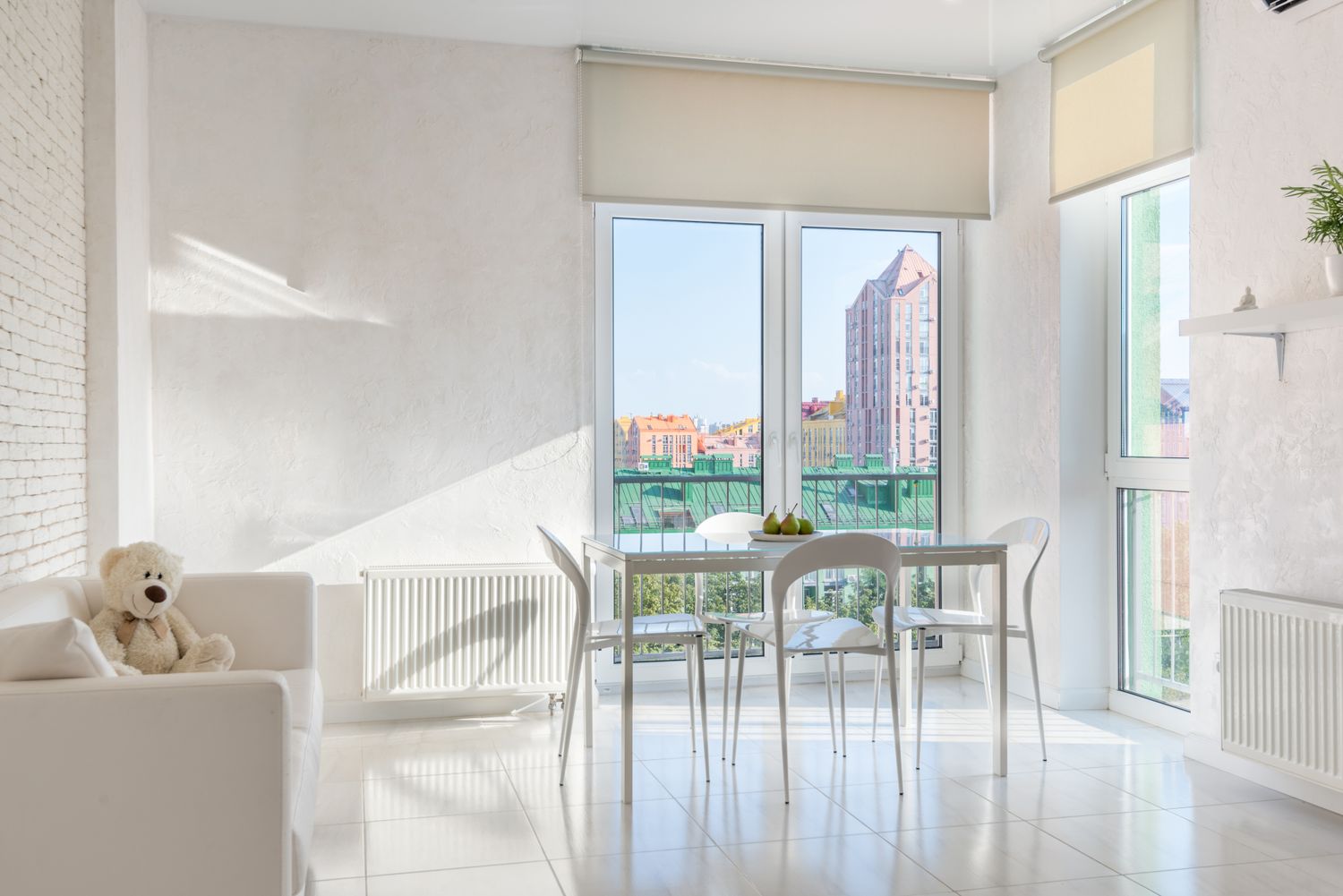 A bright, freshly cleaned living and dining area with white tile floors