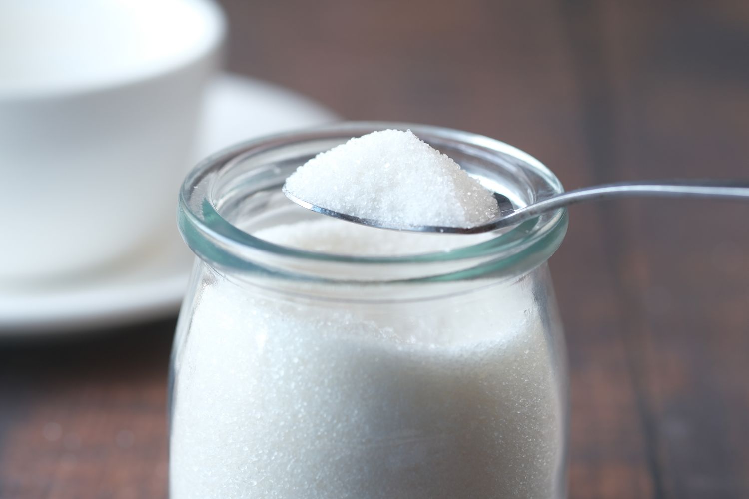 A spoonful of baking soda over an open glass jar