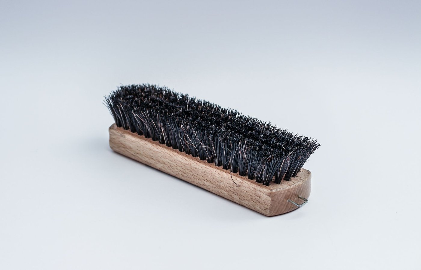 A stiff-bristled scrub brush for grout and tile