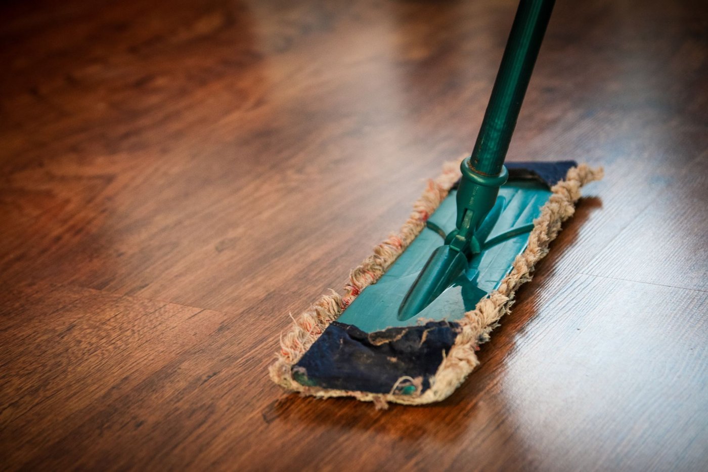 A flat mop gliding across a glossy hardwood floor