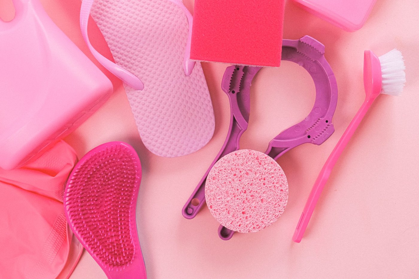 A flat lay of cleaning supplies: brushes, sponges and spray